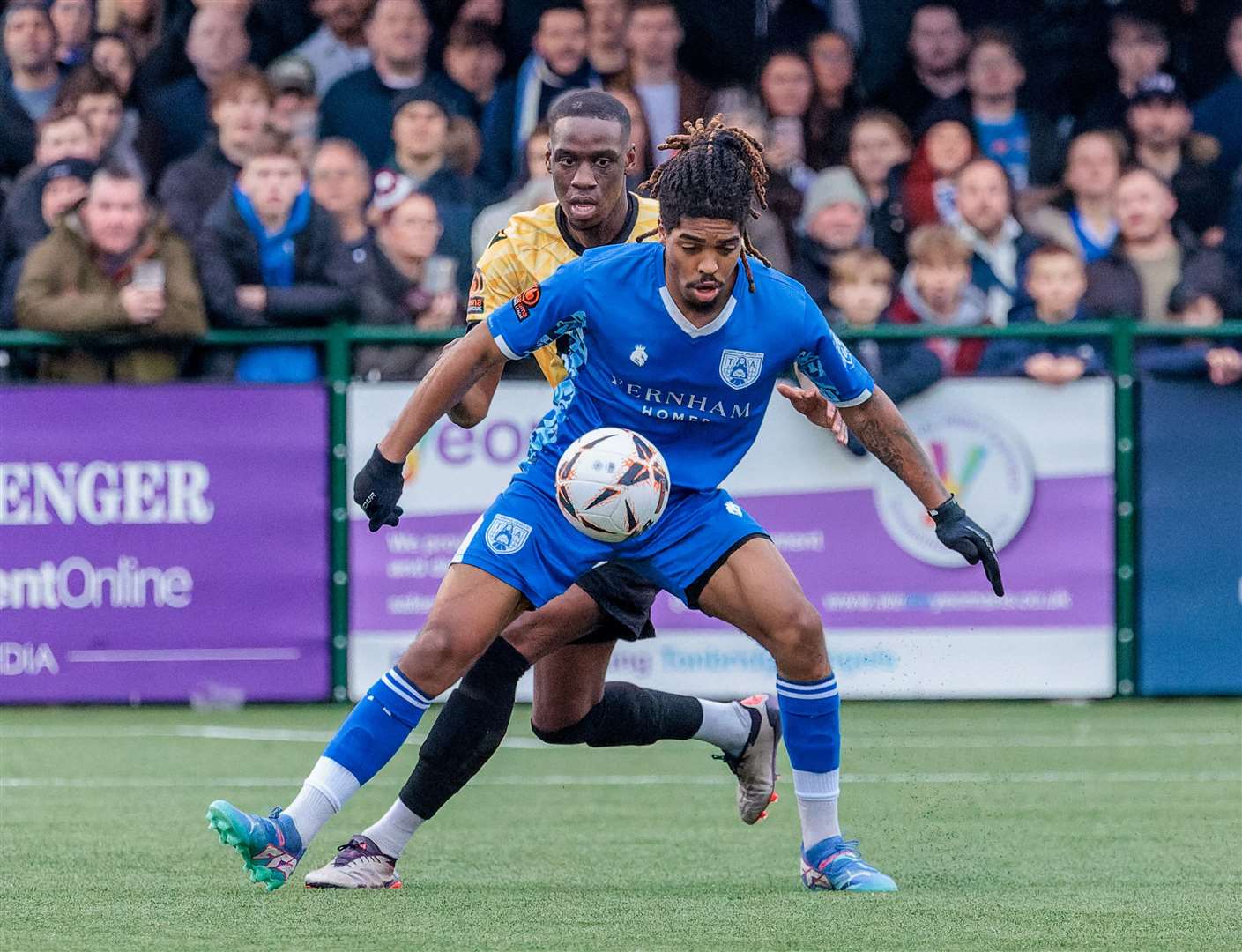 Tonbridge forward Trevan Robinson shields the ball from Maidstone defender Temi Eweka. Picture: Helen Cooper