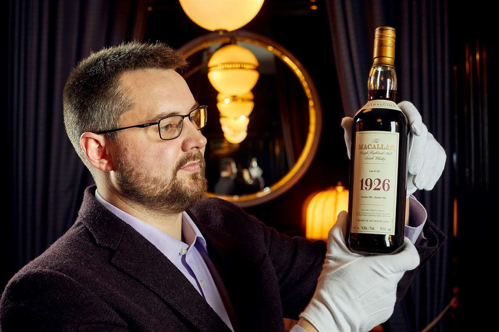 Whisky Auctioneer founder Iain McClune with the bottle of Macallan 1926 Fine and Rare 60 Year Old (Peter Dibden/Whisky Auctioneer/PA)