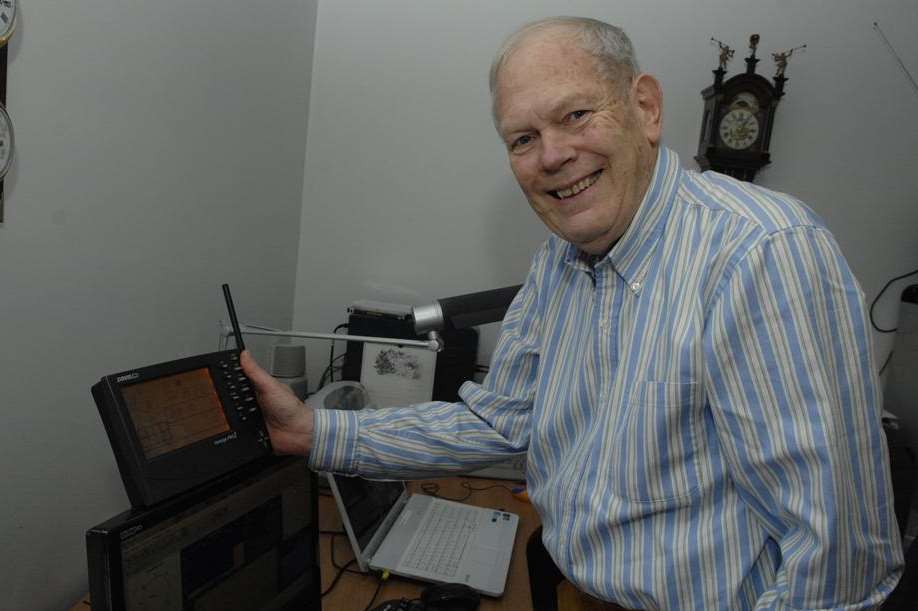 Jeremy Procter checks the data on his weather monitoring station