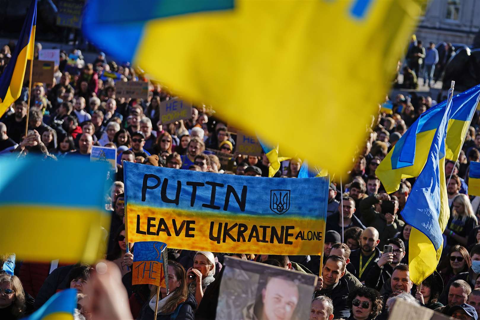 People take part in a demonstration in Trafalgar Square, London, to denounce the Russian invasion of Ukraine (Rebecca Speare-Cole/PA)