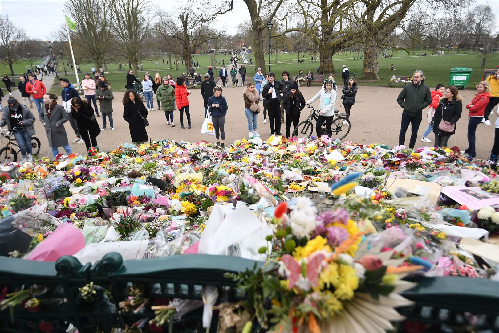 People view floral tributes to Sarah Everard at the bandstand on Clapham Common in south London (Victoria Jones/PA)