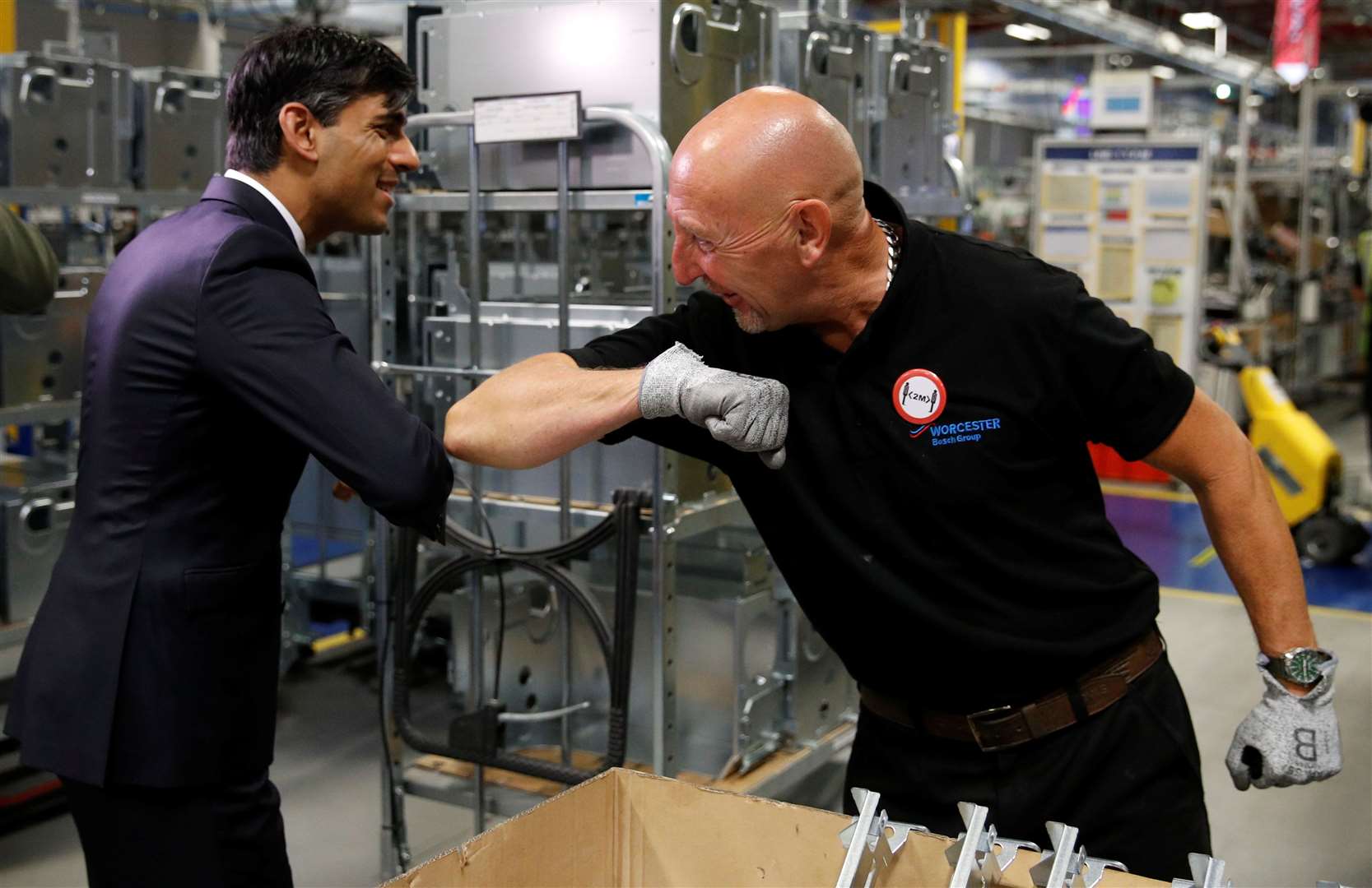 Chancellor Rishi Sunak greets an employee with an elbow bump during his visit to Worcester Bosch factory (Phil Noble/PA)