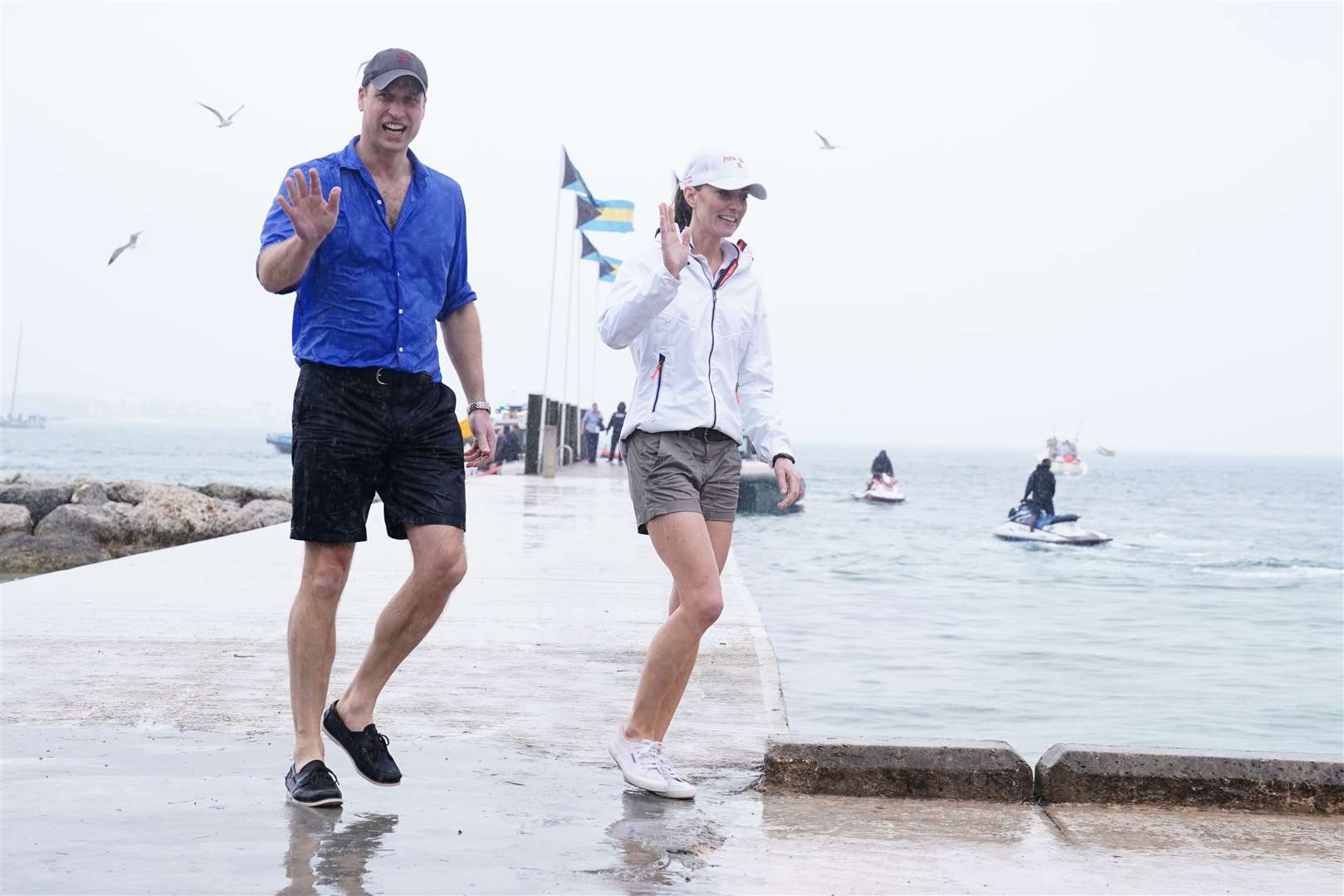 A drenched William and Kate step onto land after sailing in a regatta in the Bahamas (Jane Barlow/PA)