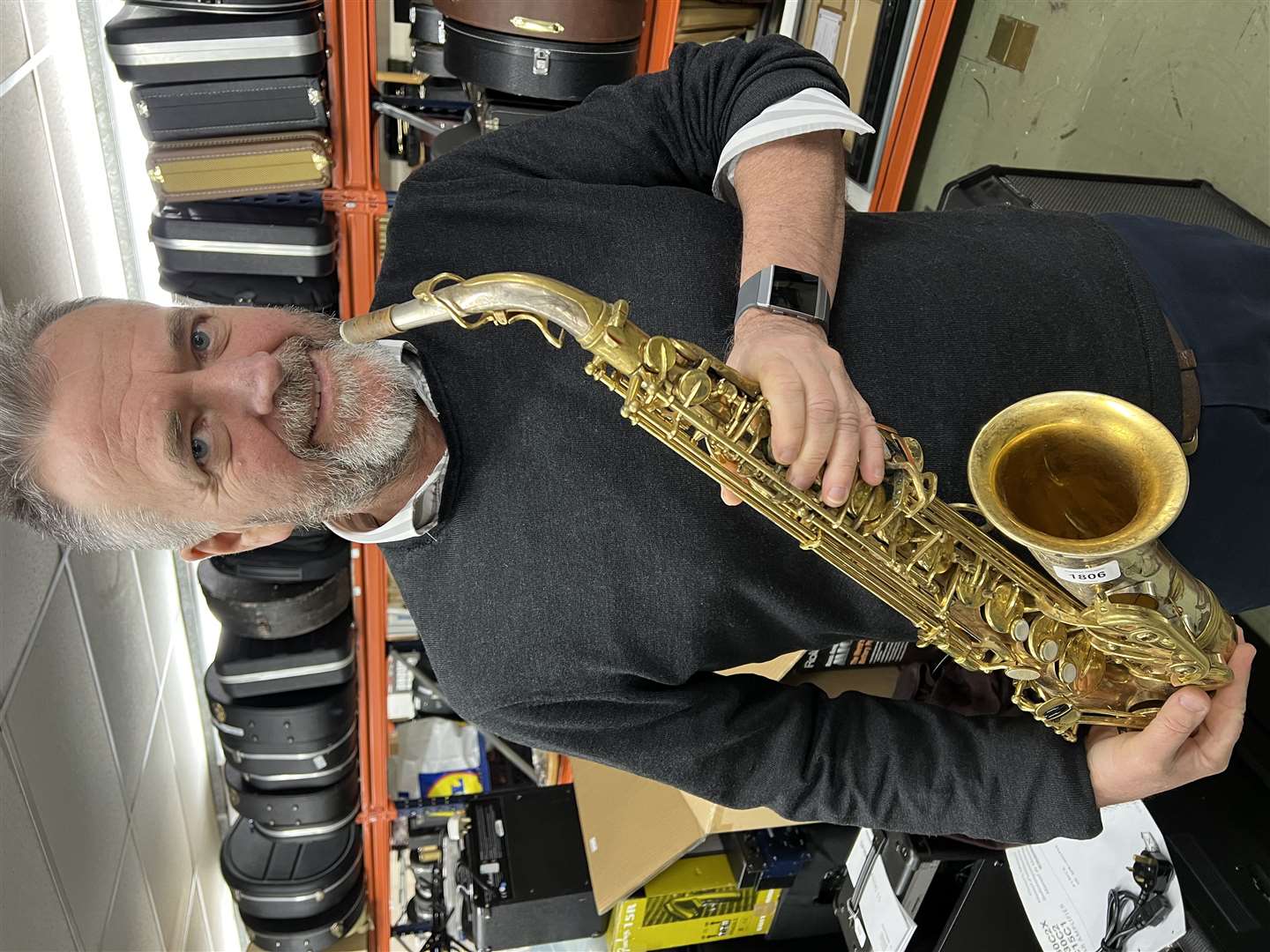 Auctioneer Jamie South with a saxophone that belonged to Peter King (Gardiner Houlgate/PA)