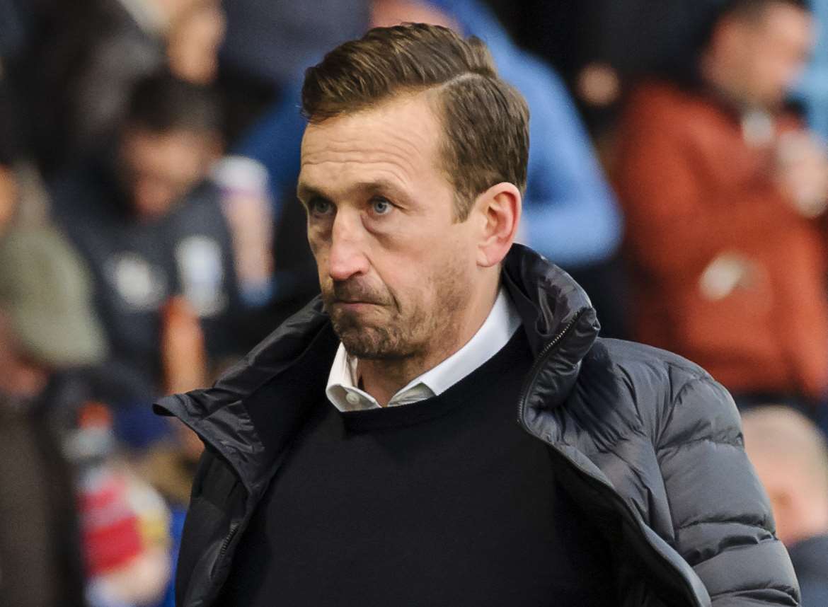 Justin Edinburgh walks off after his last game in charge of Gillingham Picture: Andy Payton