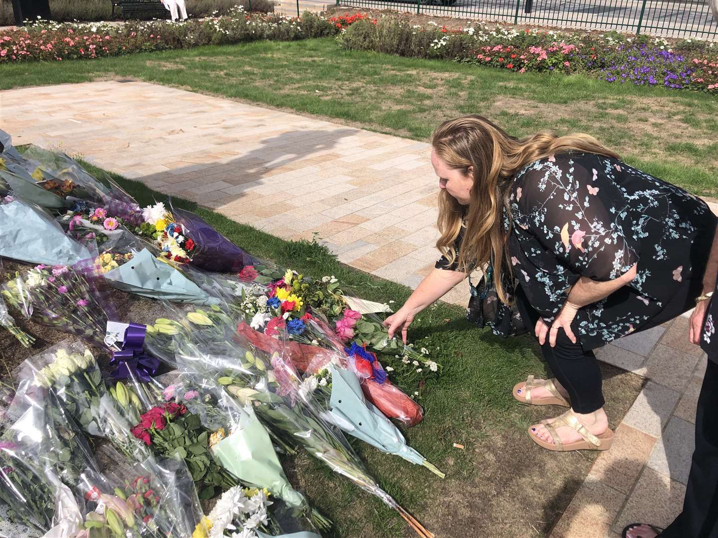 Tanya Aldam laying her bunch of flowers