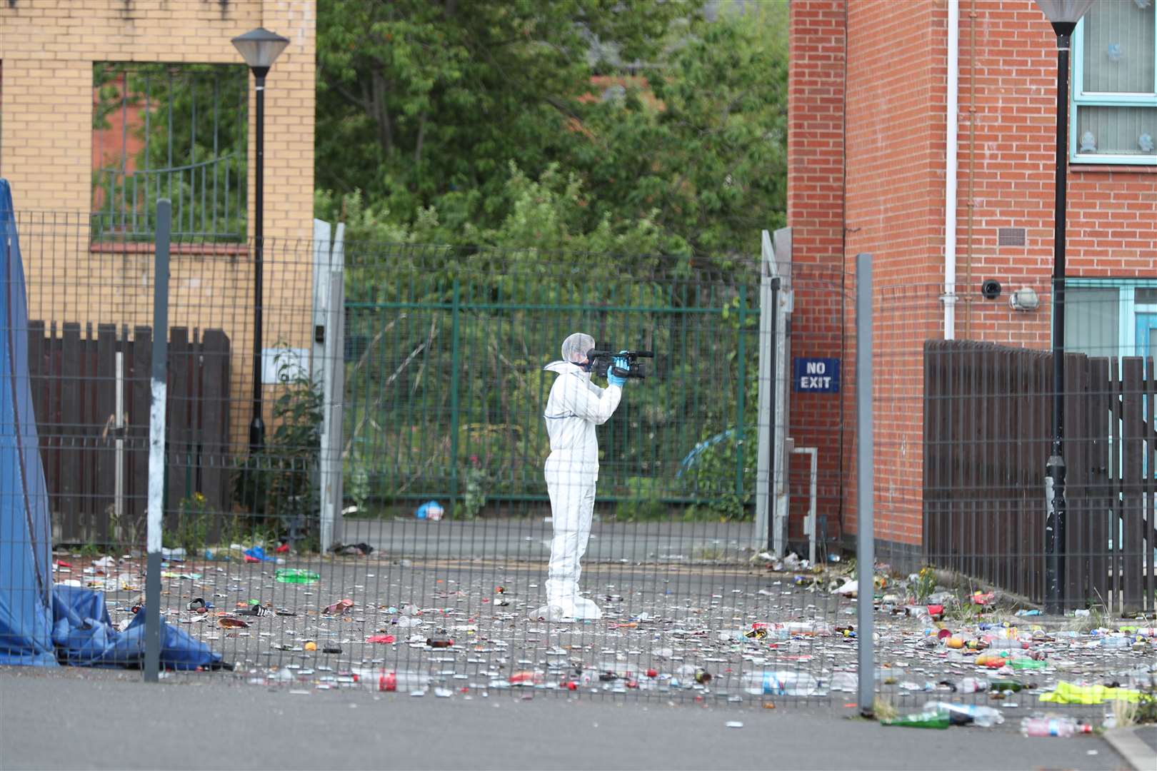 A scene of crime officer takes photos at the site of a fatal shooting in Manchester (Peter Byrne/PA)