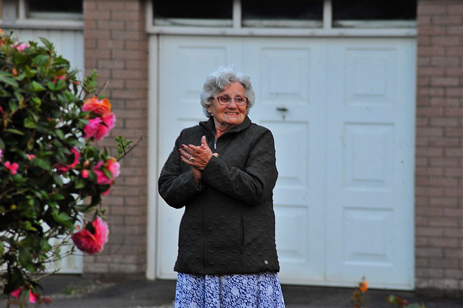 Jean Pool clapping in Gosforth, West Cumbria, to salute local heroes (Oliver Hodgson/PA)