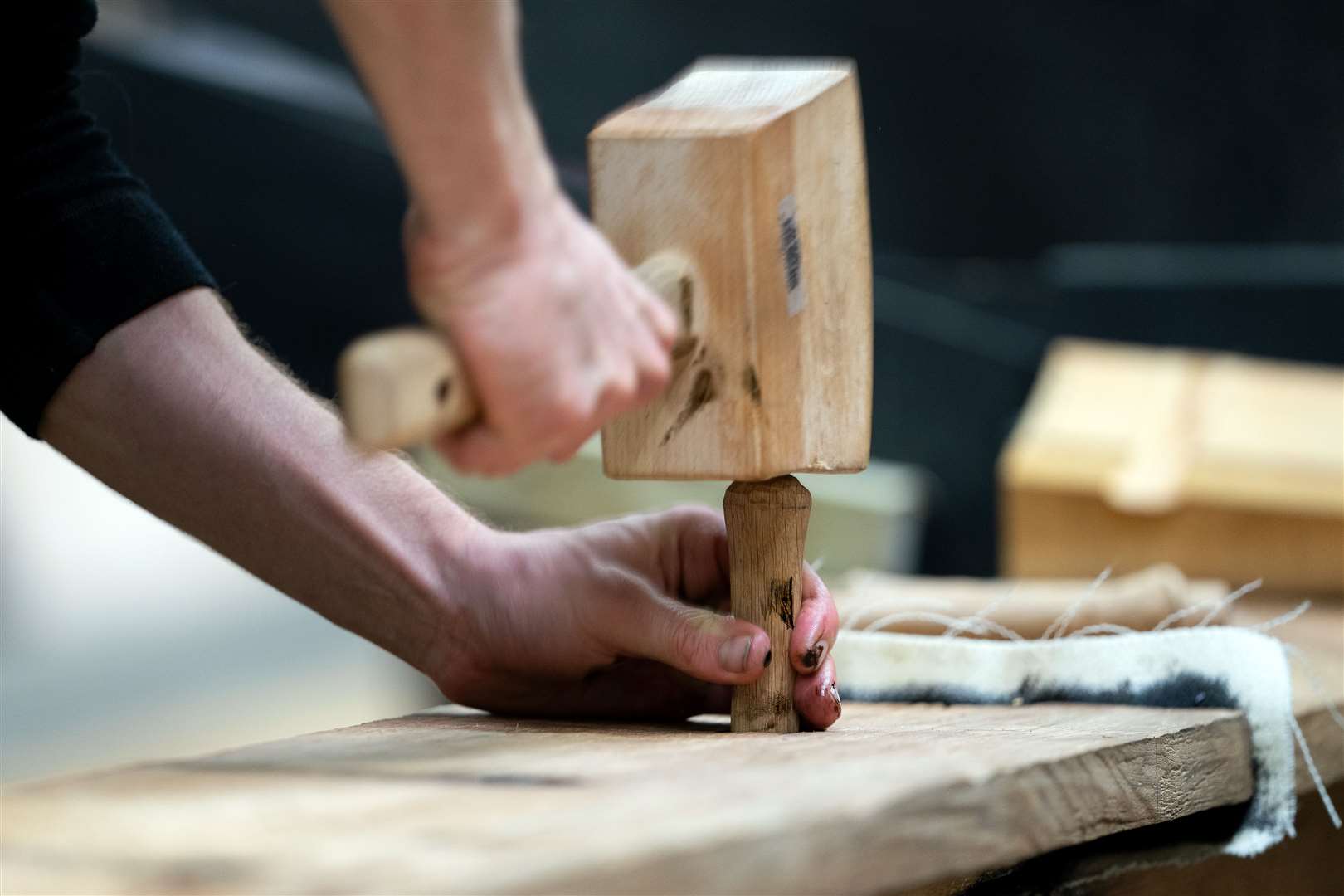 A trenail is hammered in to join the first two finished parts of the vessel (Joe Giddens/PA)