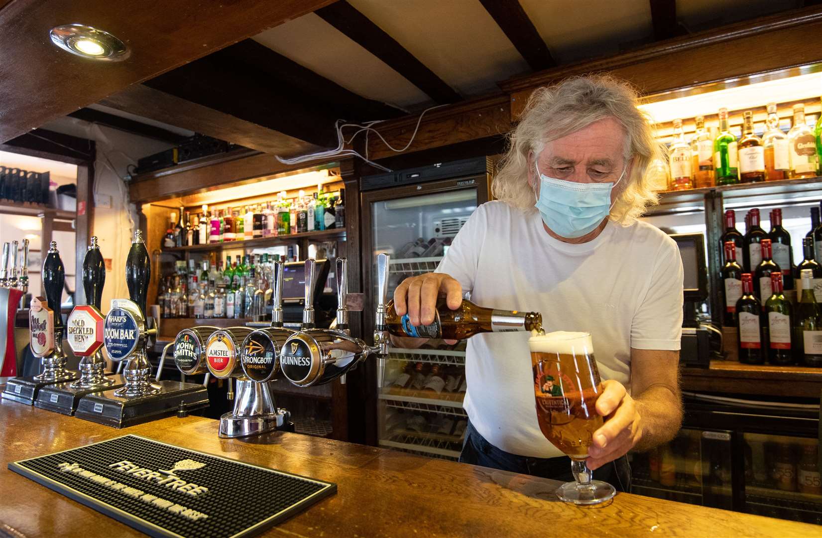 Phil Weaver, owner of The Old Smithy in Church Lawford, Warwickshire pours a pint (Joe Giddens/PA)