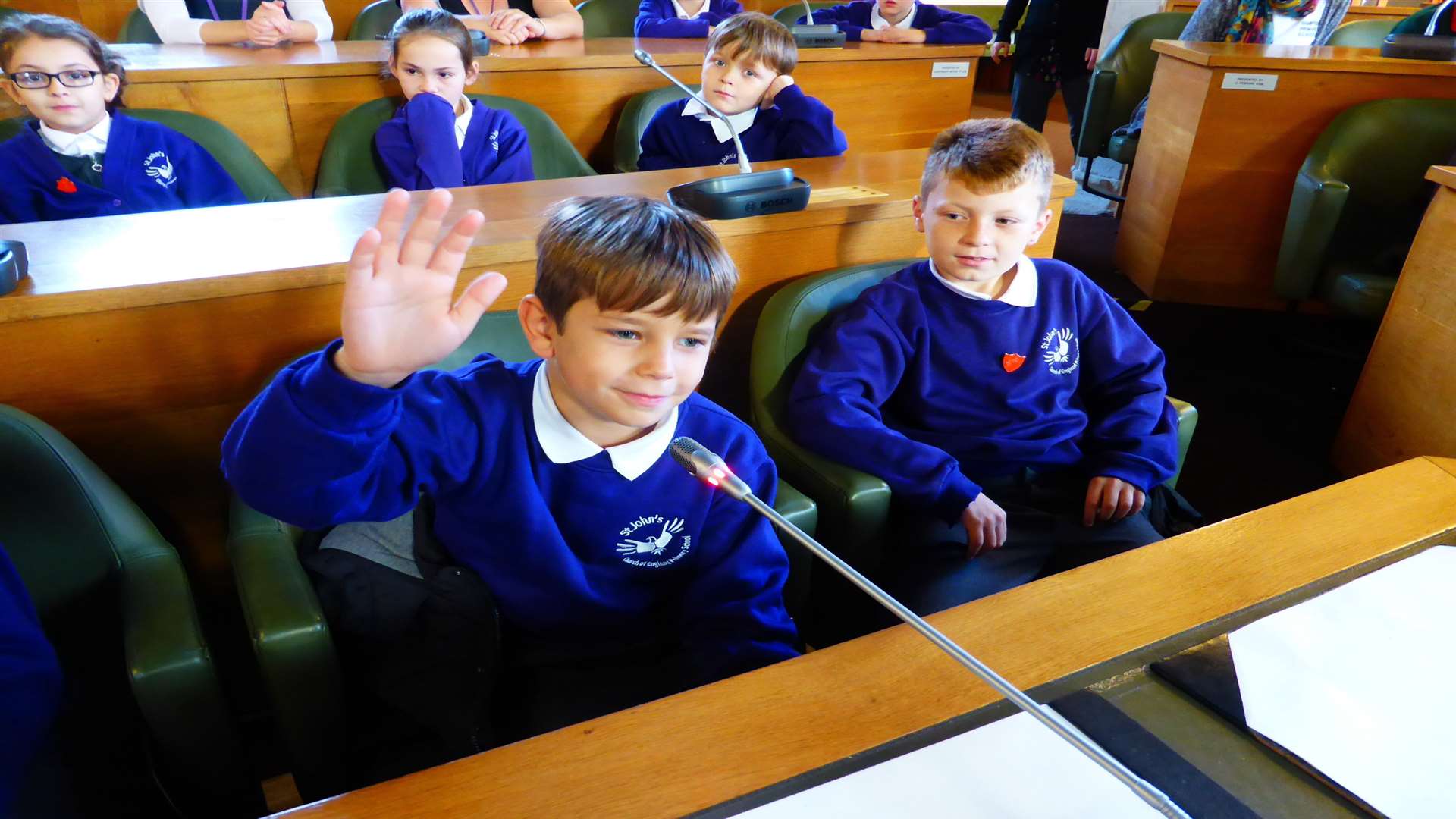 Morgan Green, 10, of St John's School, Canterbury asks the Green Champion panel a question on air pollution issues, watched by Roylee Granger, 10.