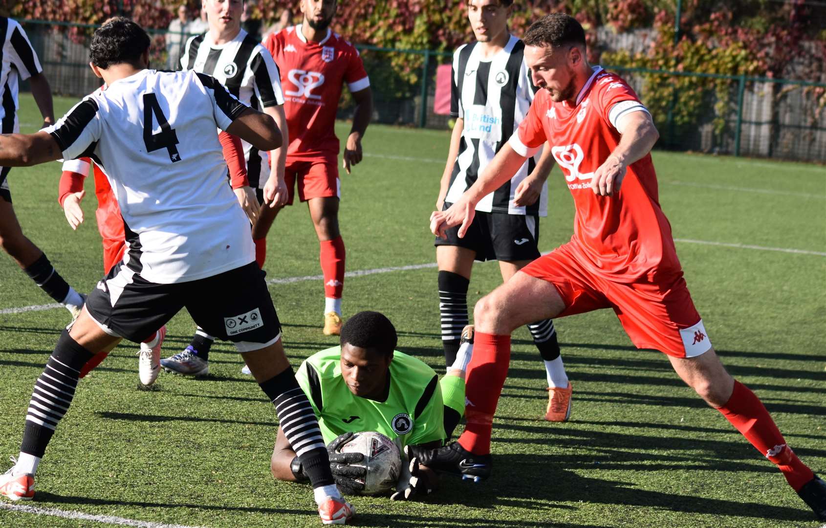 Faversham's Ben Gorham is foiled by Fisher goalkeeper Isaac Ogunseri. Picture: Alan Coomes