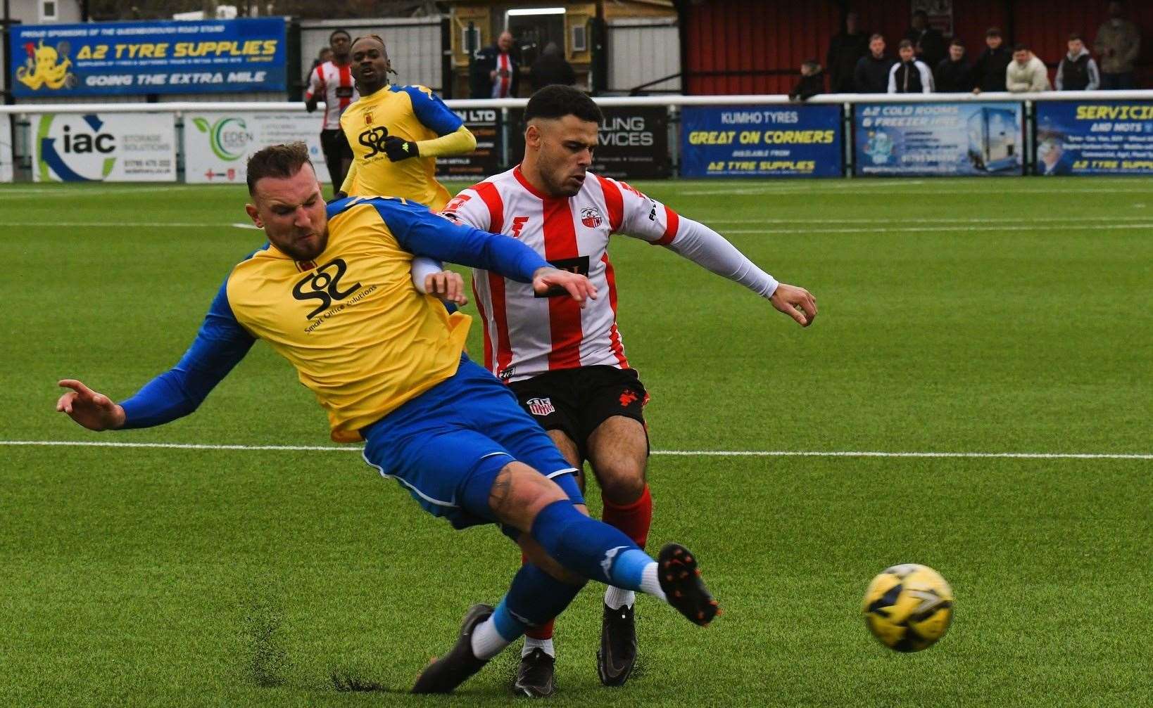 Faversham defender Darren Phillips puts in a challenge on Sheppey's ex-Faversham midfielder Bradley Schafer. Picture: Marc Richards