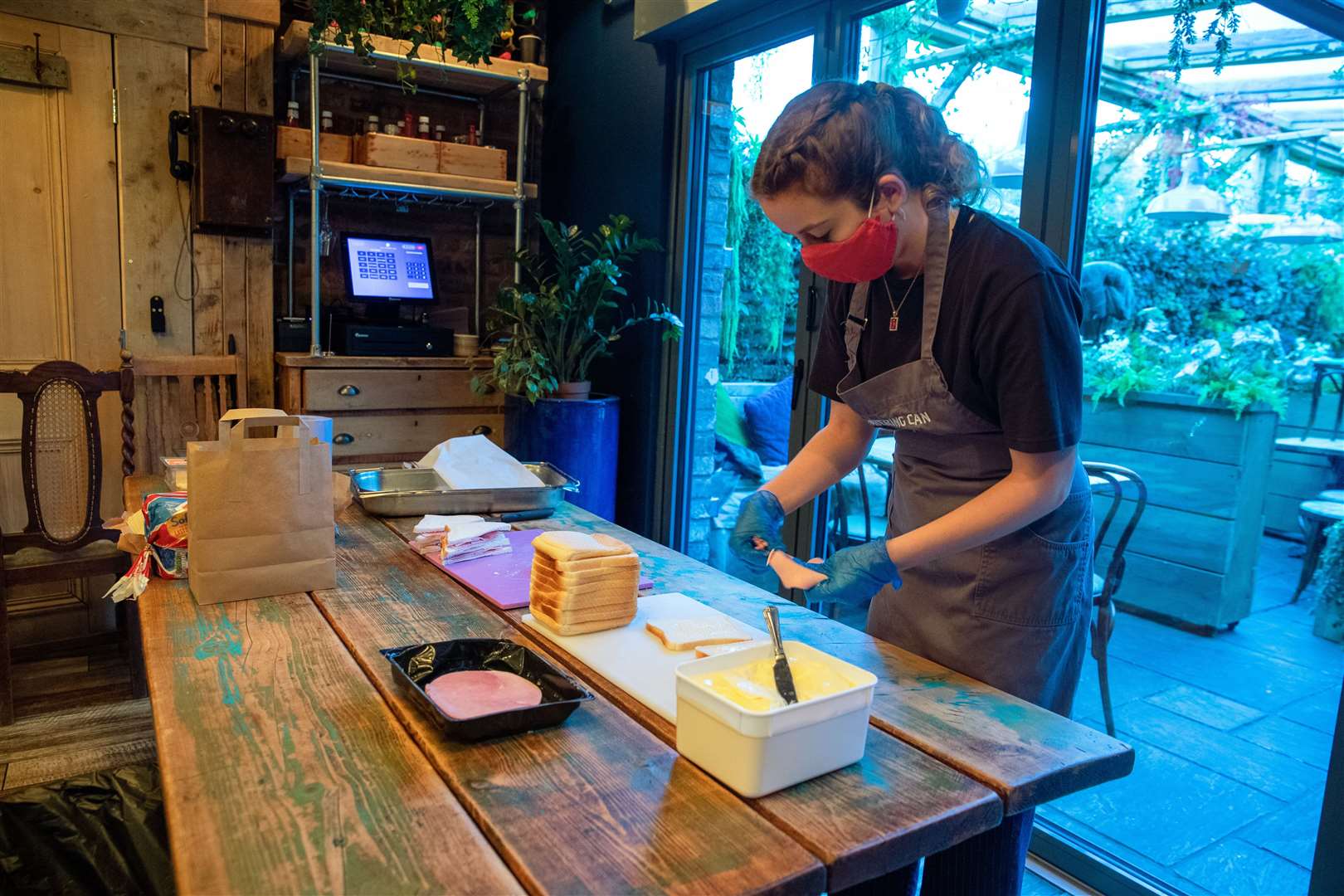 Helen Manning prepares sandwiches at The Watering Can, in Greenbank Park, Liverpool (Peter Byrne/PA)