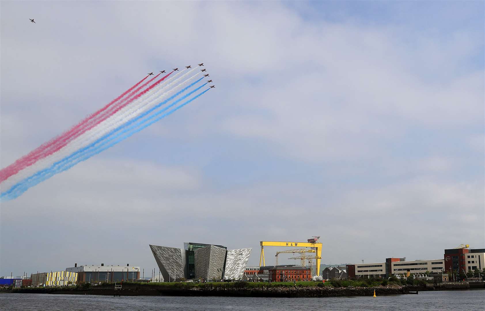 The Red Arrows fly over the Titanic slipway, the Titanic Museum and the Samson and Goliath cranes in Belfast (Brian Lawless/PA)