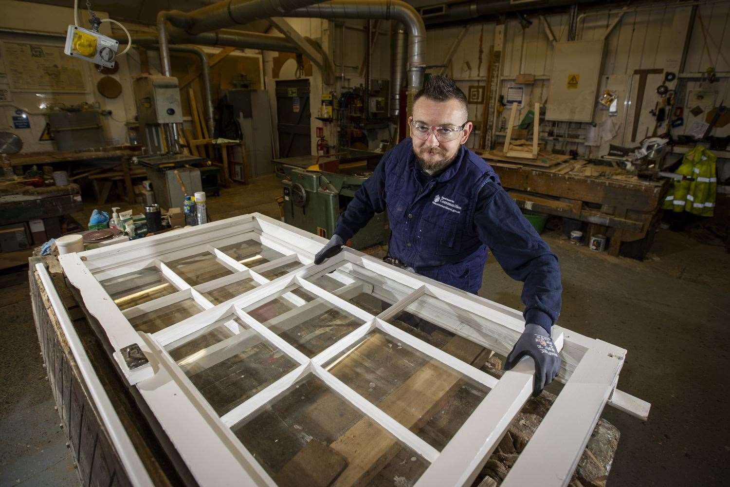 Conservation joiner David McFerran working on a set of sash windows (Liam McBurney/PA)