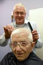 Joe Taylor has his hair cut by David Elphee. Picture by David Antony Hunt