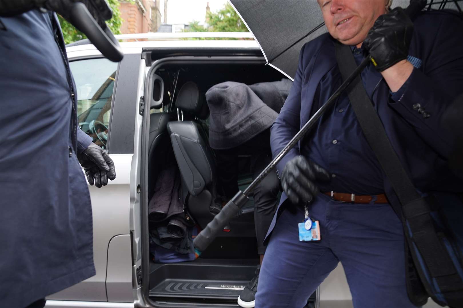 West Ham defender Kurt Zouma tried to shield his face when he arrived at Thames Magistrates’ Court last week, assisted by security (Yui Mok/PA)