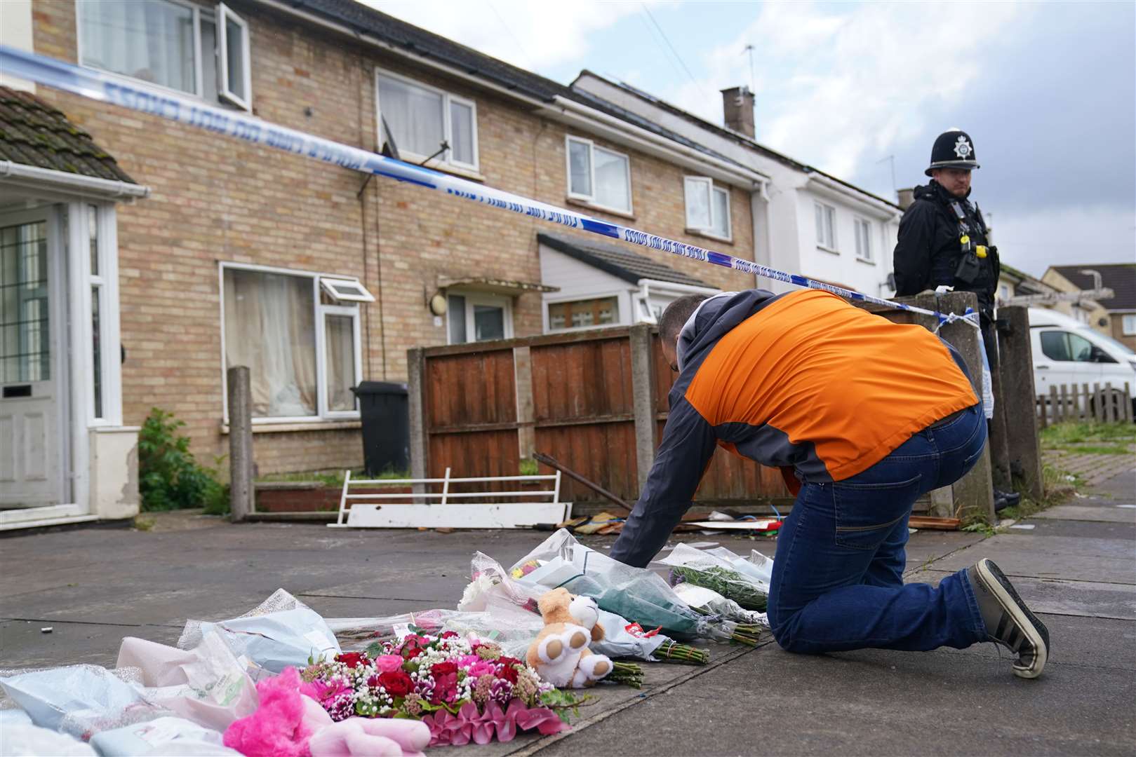 Tributes have been left outside the house (Jacob King/PA)