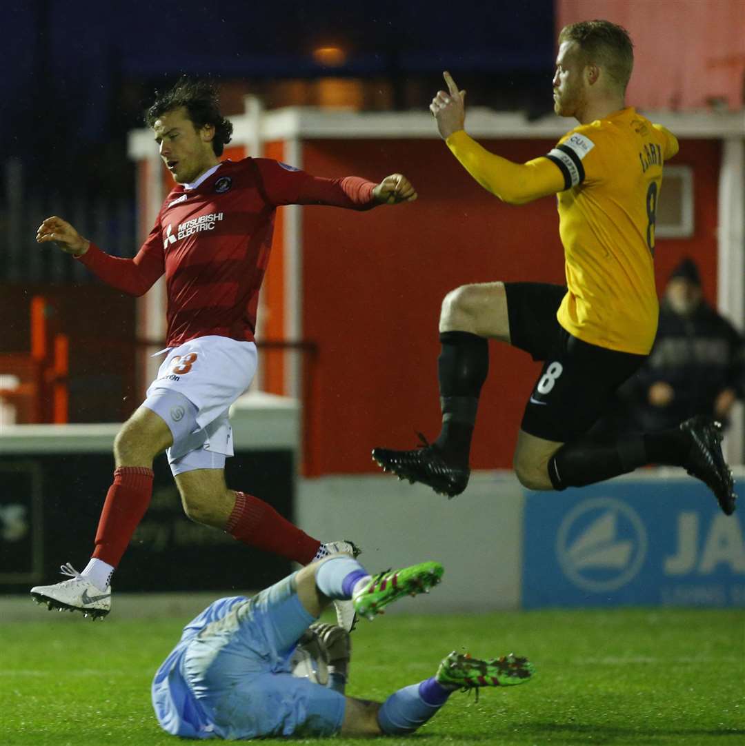 Laurie Wilson leaps into action chased by former Fleet player Kenny Clark Picture: Andy Jones