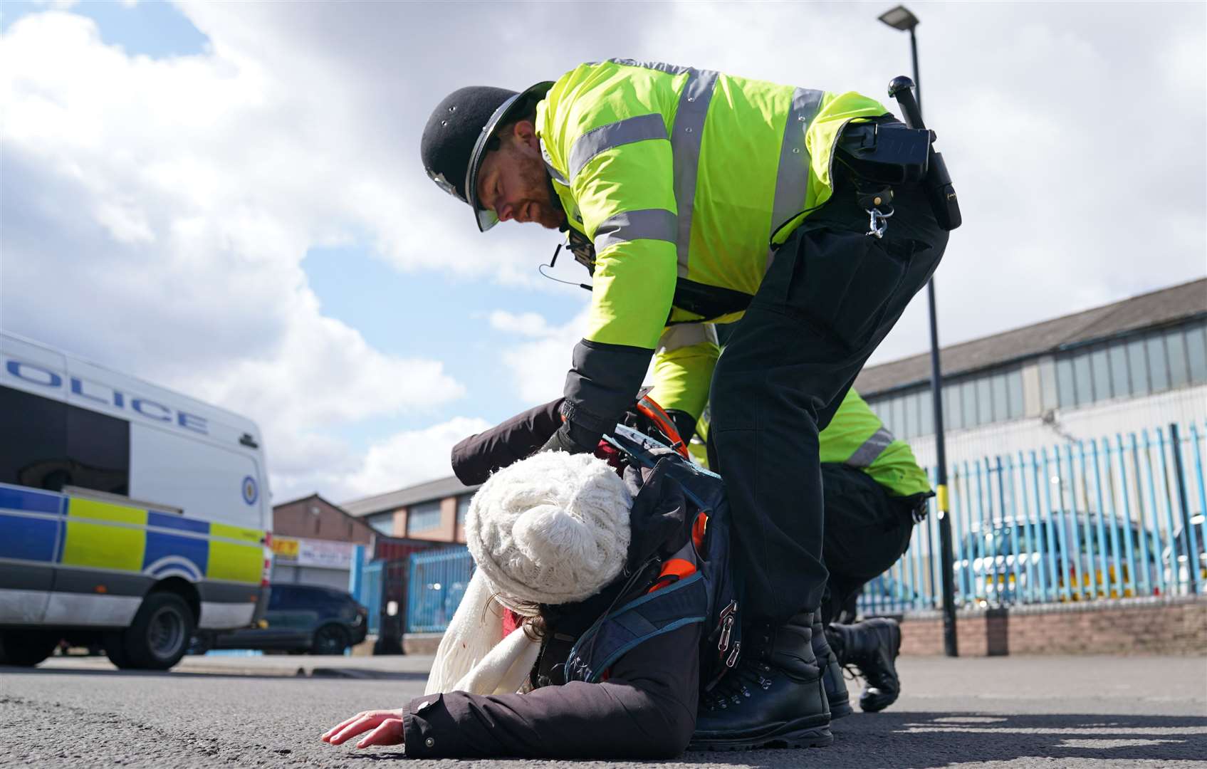 Police remove a Just Stop Oil activist taking part in a blockade of the Esso Birmingham Fuel Terminal, Birmingham, on Friday (Joe Giddens/PA)