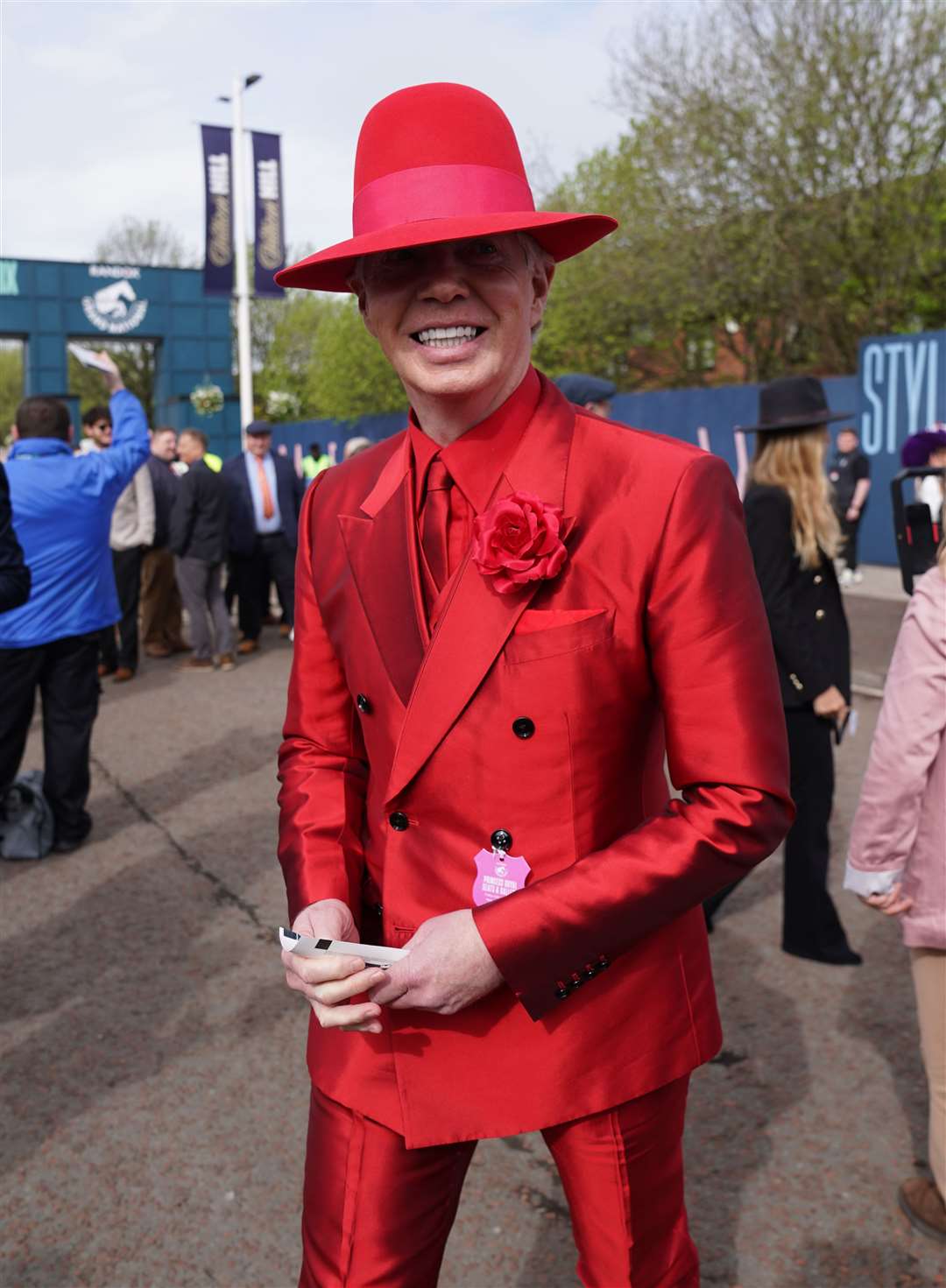 A racegoer makes their mark at Aintree Racecourse (Bradley Collyer/PA)