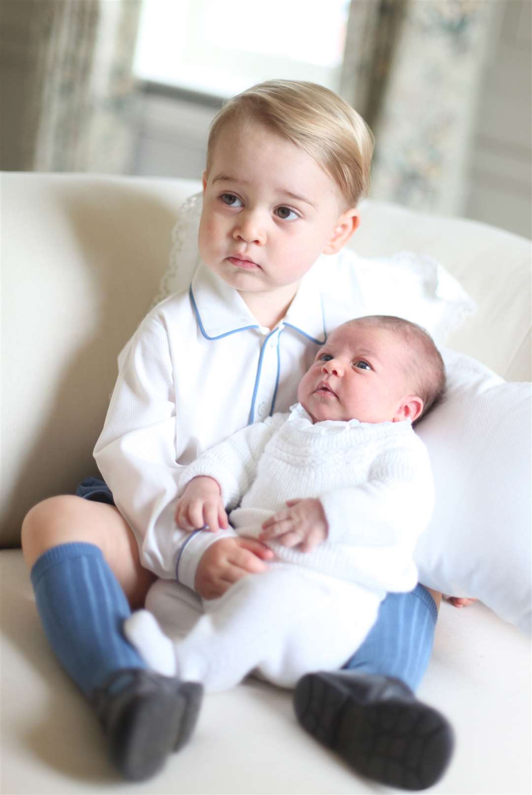 Kate shared a picture of a serious-faced George holding his baby sister (Duchess of Cambridge/PA)