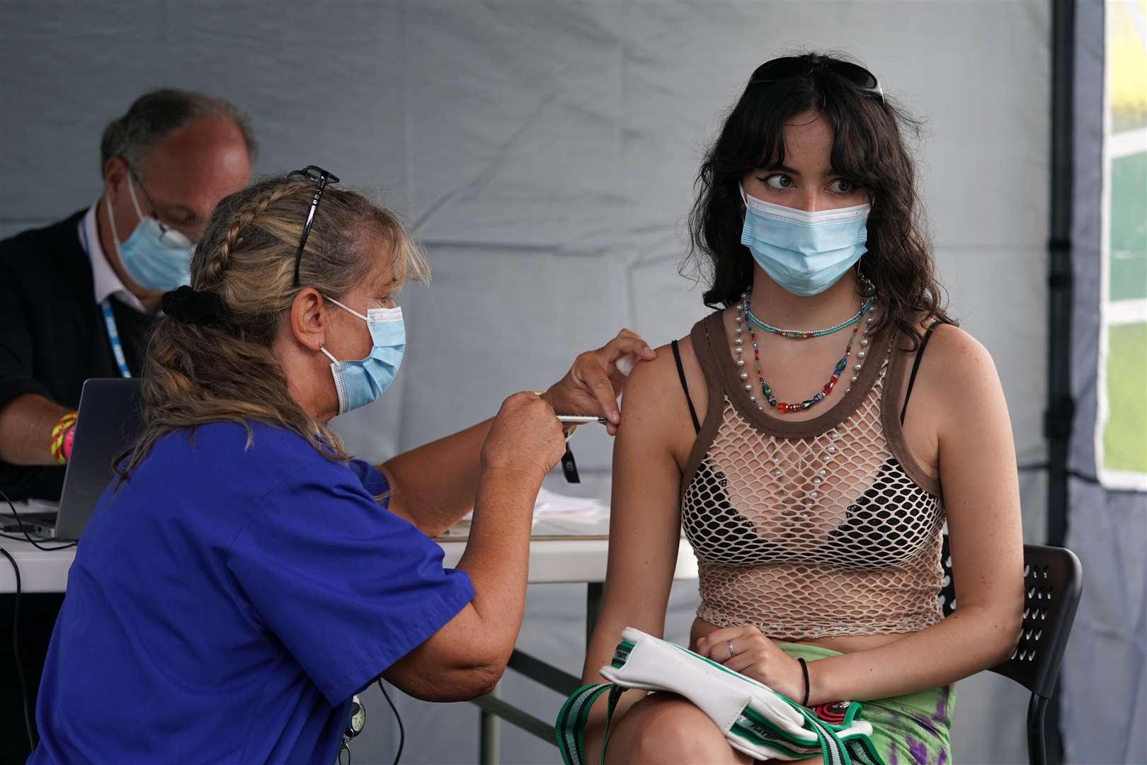 Sixteen-year-old year old Sofia Parkinson getting a vaccine jab at a walk-in Covid-19 vaccination clinic at the Reading Festival (Kirsty O’Connor/PA)