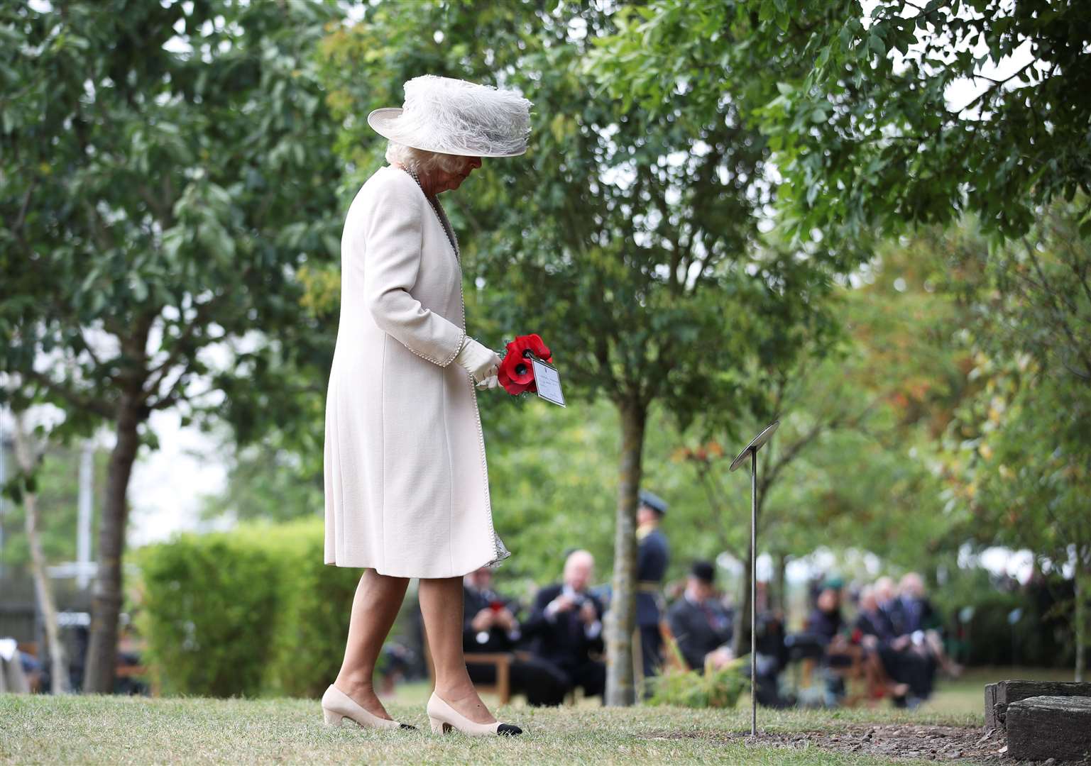 Camilla paid tribute with a poppy posy (Molly Darlington/PA)