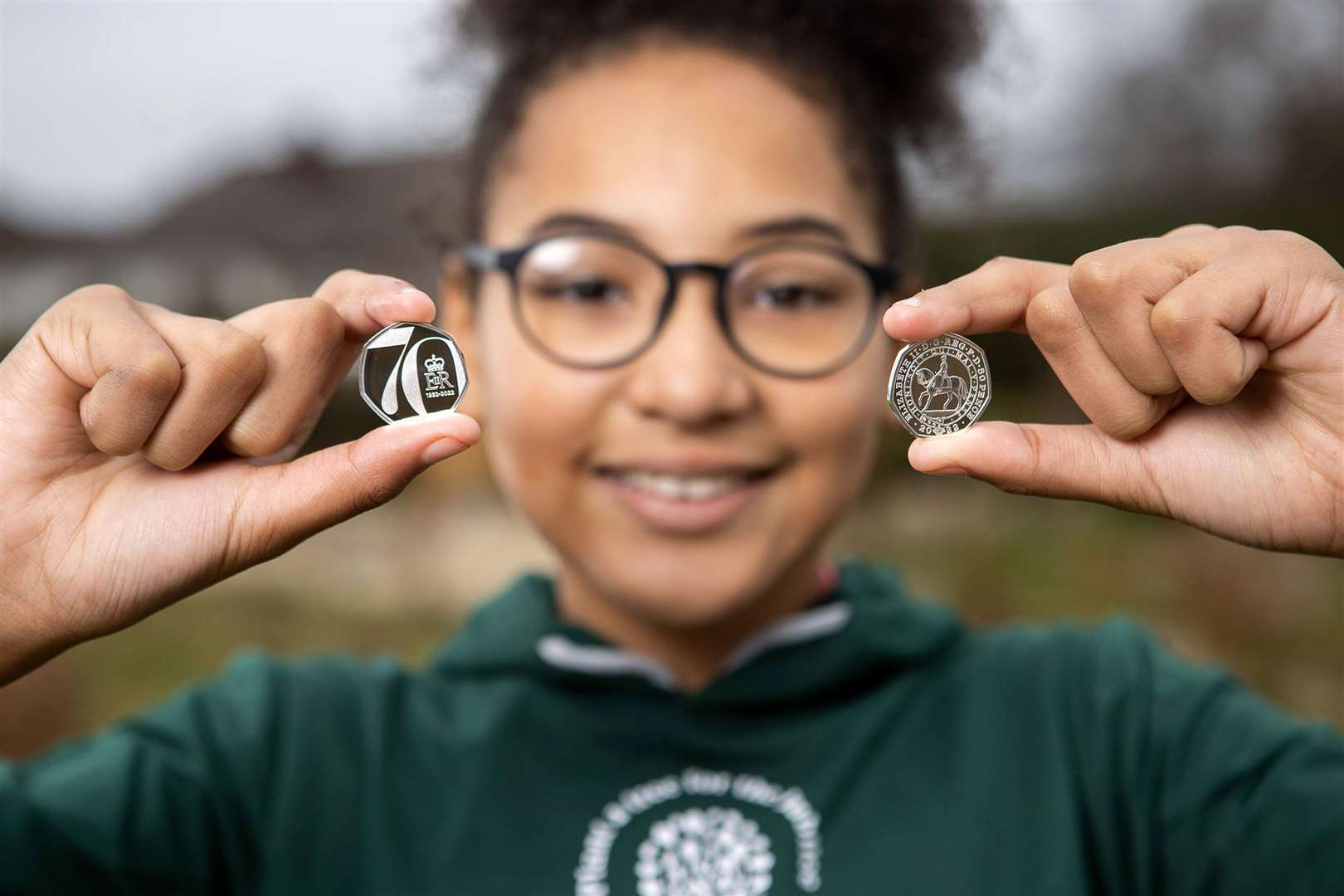 Children at Saltford C of E Primary School in Bristol with the new Platinum Jubilee 50p which will be gifted to 7,000 children completing the QGC Forestry Award (Royal Mint/PA)