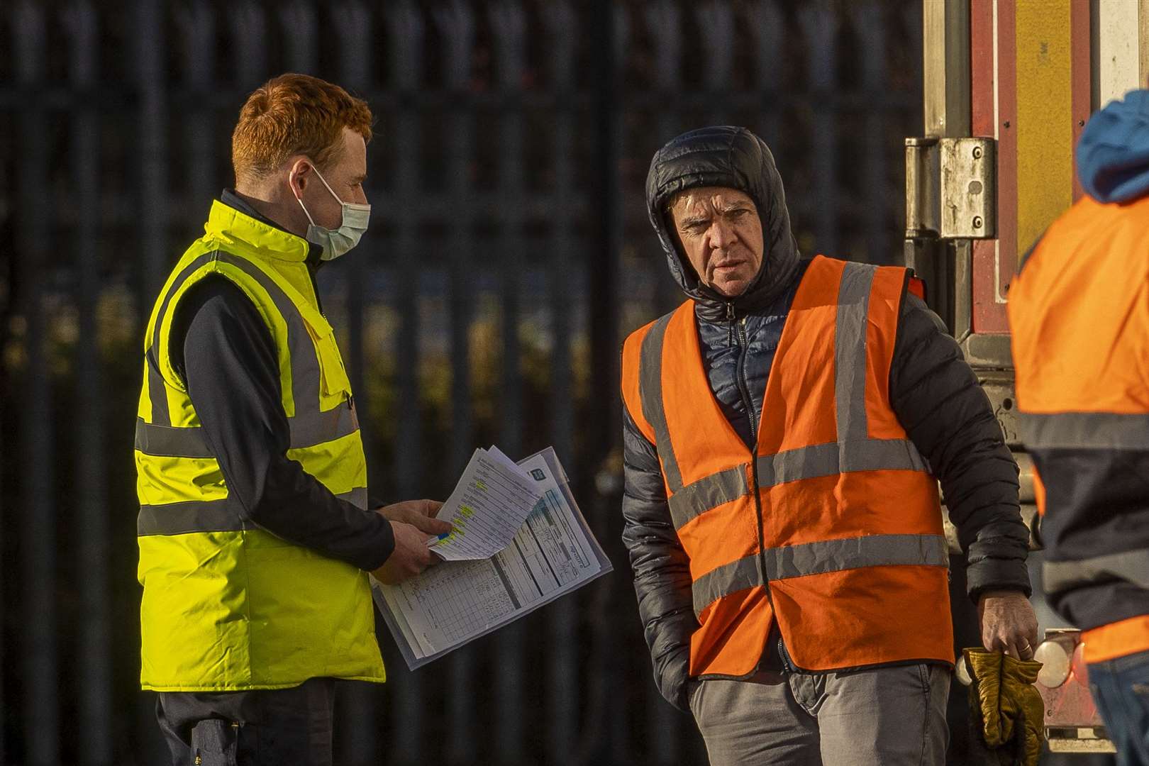 An official from the Department of Agriculture, Environment and Rural Affairs (left) talks to a lorry driver at the inspection site (Liam McBurney/PA)