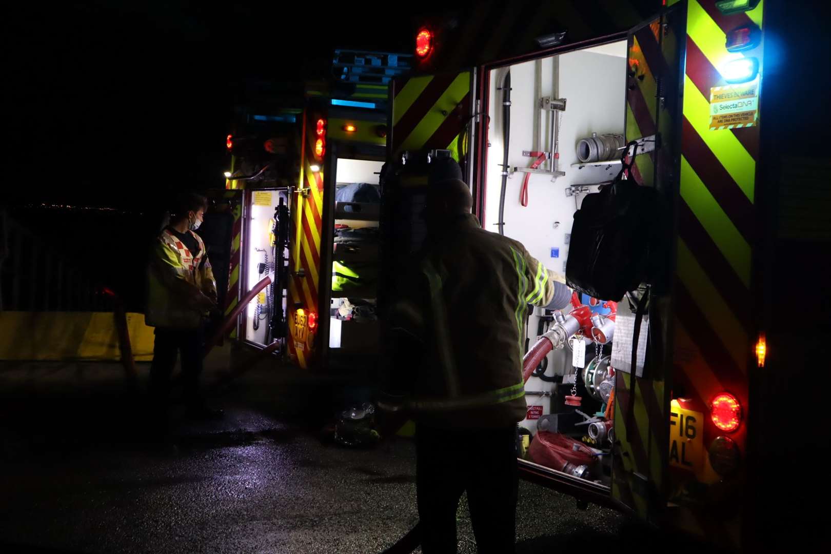 Fire engines on the scene at night. Stock photo