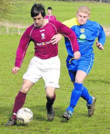 Two-goal Wayne Fittall takes on the Romney defence