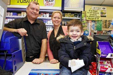 Martin Fitch, his sister Julie Back and Oliver Smith with the money staff at BA Fitch newsagents have replaced after a collection box was stolen