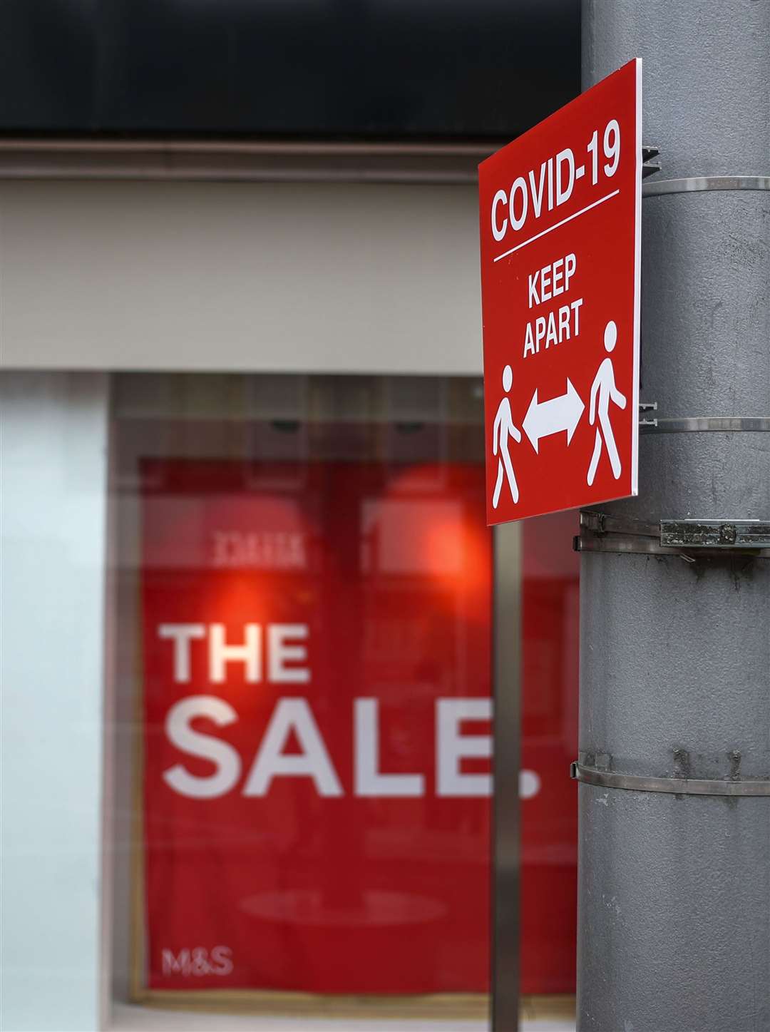 A social distancing information sign in front of a Marks and Spencer shop window in Reading, Berkshire (Steve Parsons/PA)