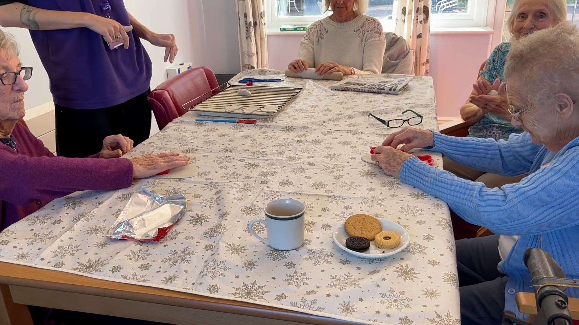 Residents at lunch-time tea together in a dining area at the home