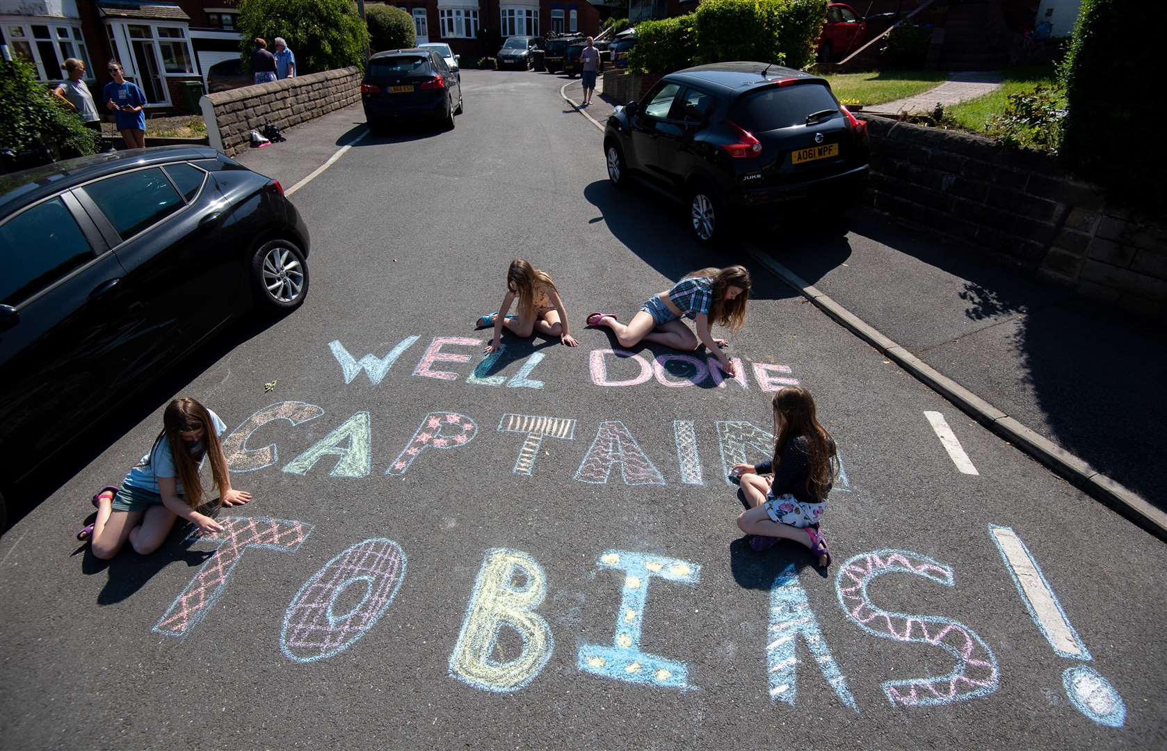 Neighbours sent messages of support to nine-year-old Tobias Weller as he completed the final leg of his marathon (Joe Giddens/PA)