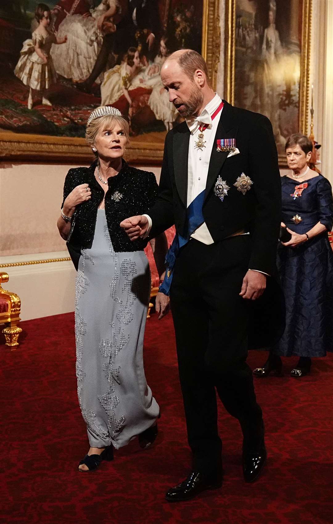 The Viscountess Hood and The Prince of Wales make their way along the East Gallery to attend the state banquet (Aaron Chown/PA)