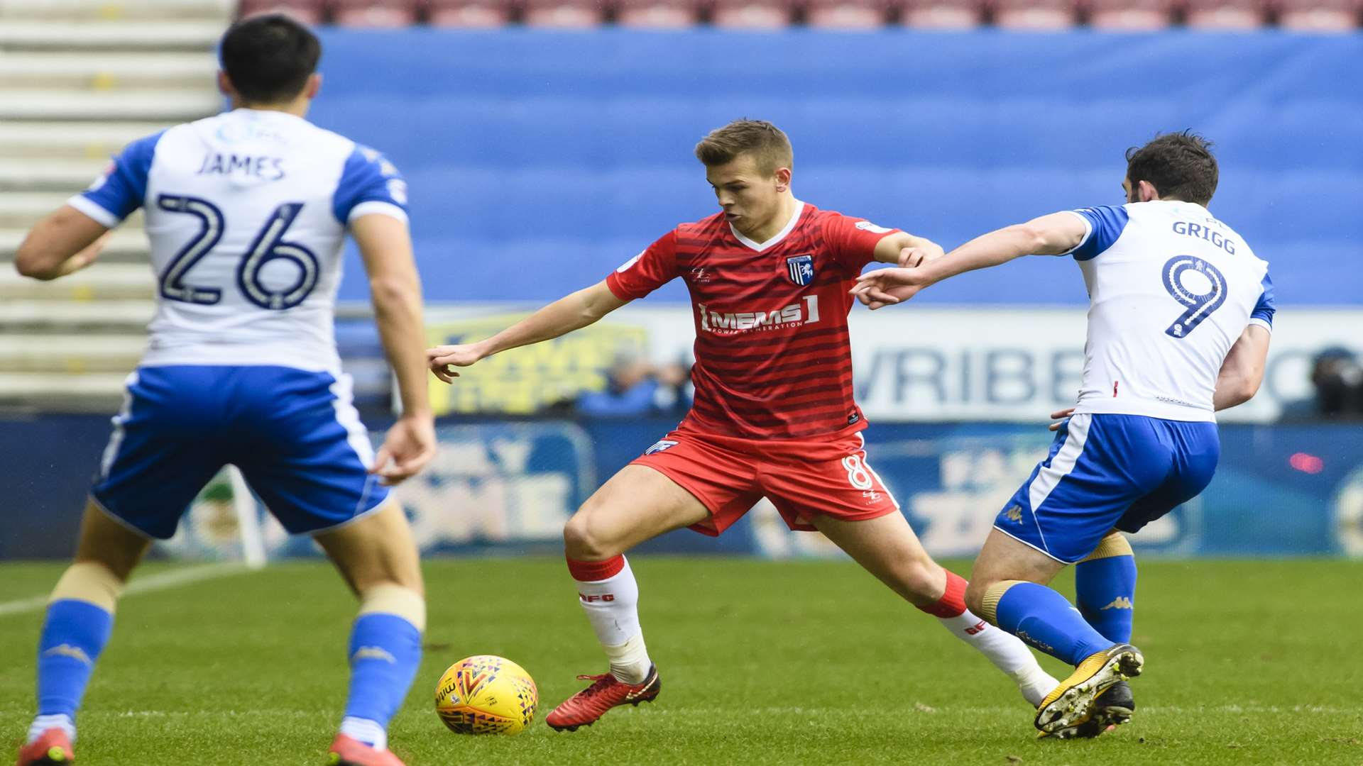 Jake Hessenthaler is pressed by Will Grigg Picture: Andy Payton