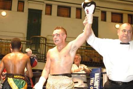 VICTORIOUS: the referee lifts Armour's arm at the end of the bout. Picture: MATT READING