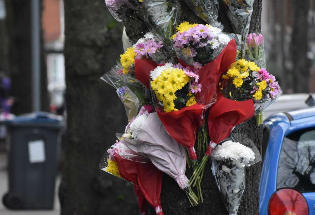 Floral tributes on a tree near the scene (Matthew Cooper/PA)