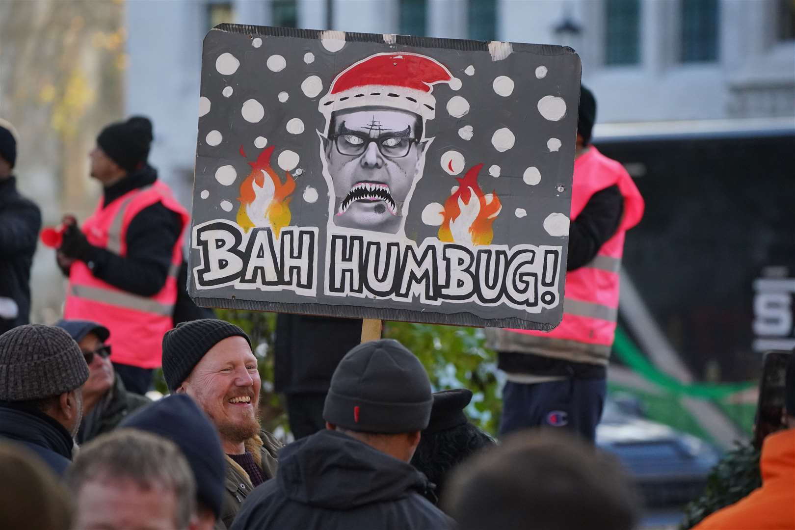 Members of the Communication Workers Union carry placards of Mr Thompson during a rally outside Parliament in December (Jonathan Brady/PA)