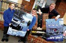 Firefighter Phil Reeve, with pupils Anne and Chad, and some of the services' flood defence posters