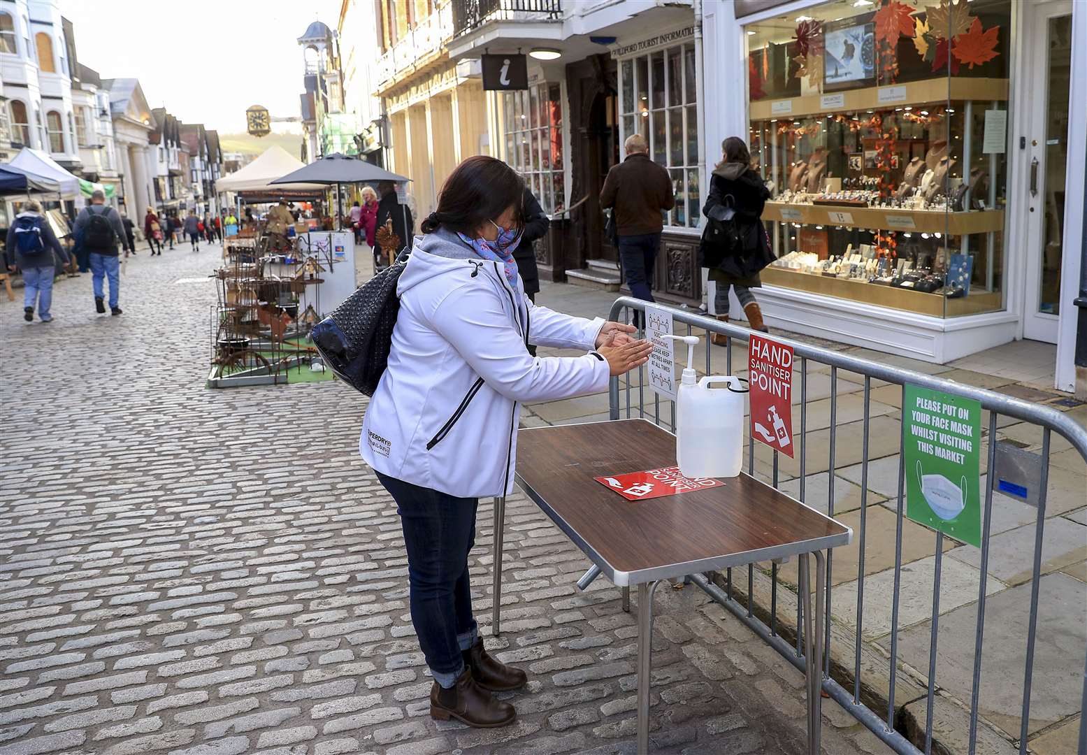 A lady uses hand sanitiser in Guildford, Surrey (Adam Davy/PA)