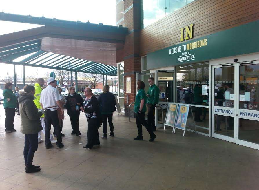 Shoppers and staff outside the shop after the evacuation