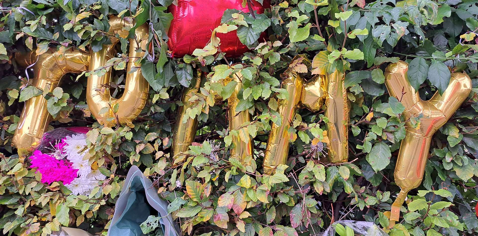 Balloons spell out "Tommy"