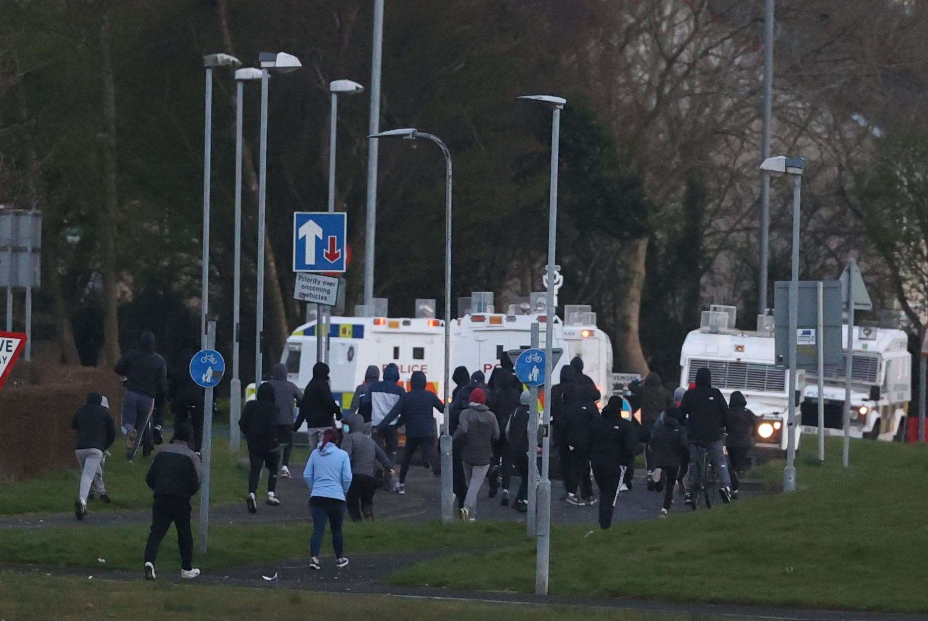 Youths gather near PSNI vehicles in Shantallow (Liam McBurney/PA)