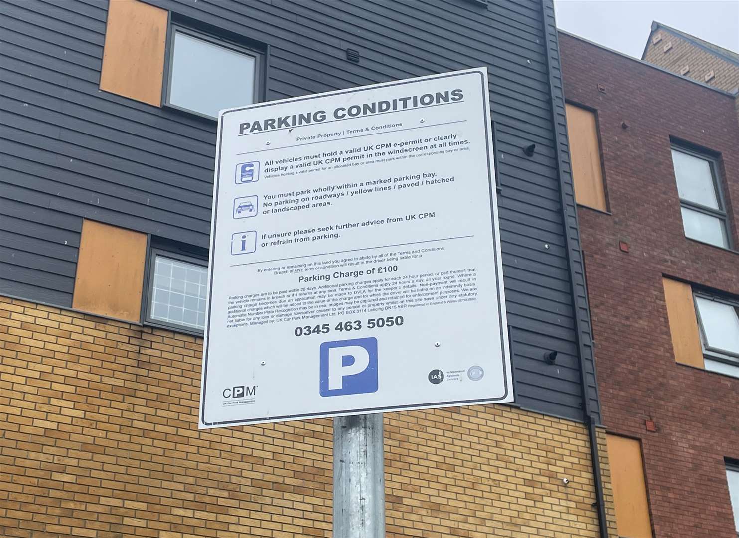 A sign which tells people they may be fined if they park in the three bays