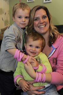 Donna Reeve, of Lodge Hill Lane, Chattenden with Jimmy Reeve, 2, and Poppy Reeve, 1, modelling wrist bands for her charity.