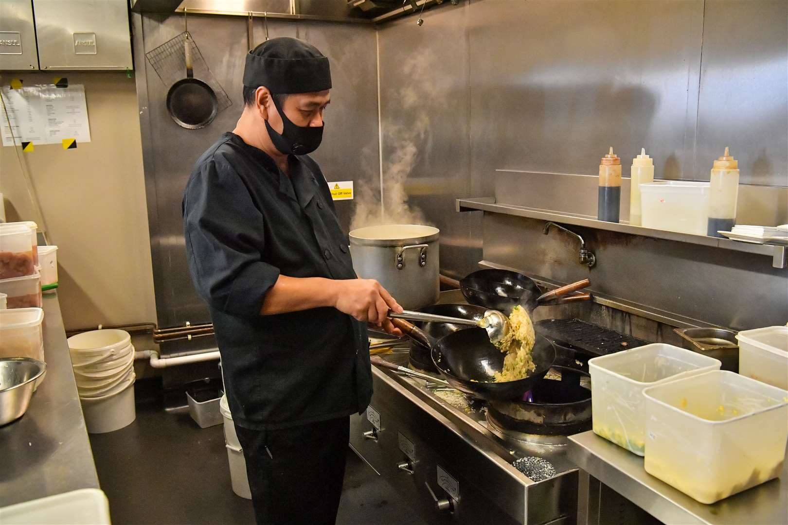 A chef prepares food for free lunch bags at Pho in Bristol (Ben Birchall/PA)